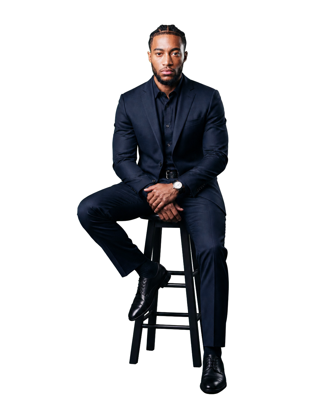 Kyle Gill seated in a navy suit on a stool